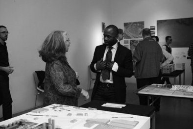 Roberta Feldman (left) and Theaster Gates (right) with Studio Gang's site plan model at the September 17 Open Studios at MoMA PS1.